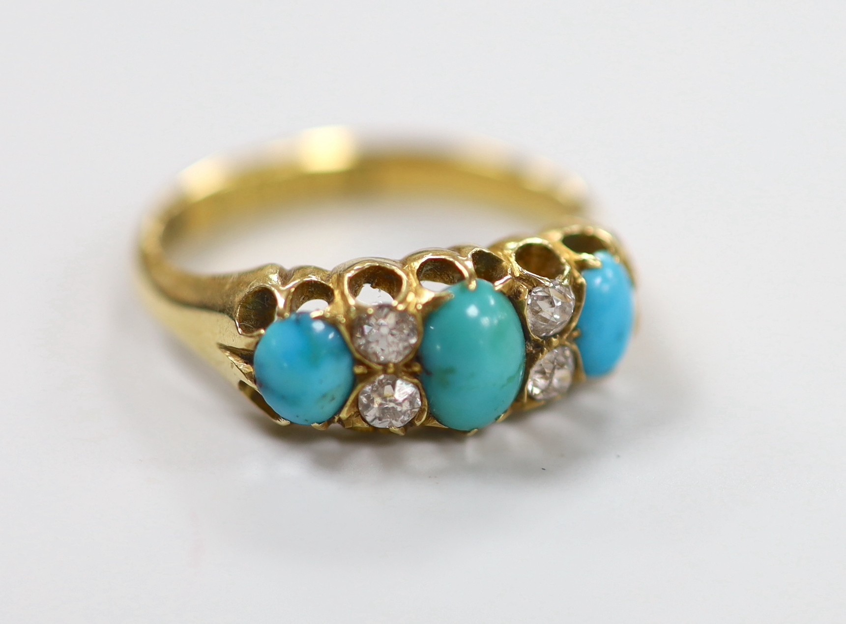 A late Victorian 18ct gold, three stone turquoise and four stone diamond set half hoop ring, size L, gross weight 3.9 grams.